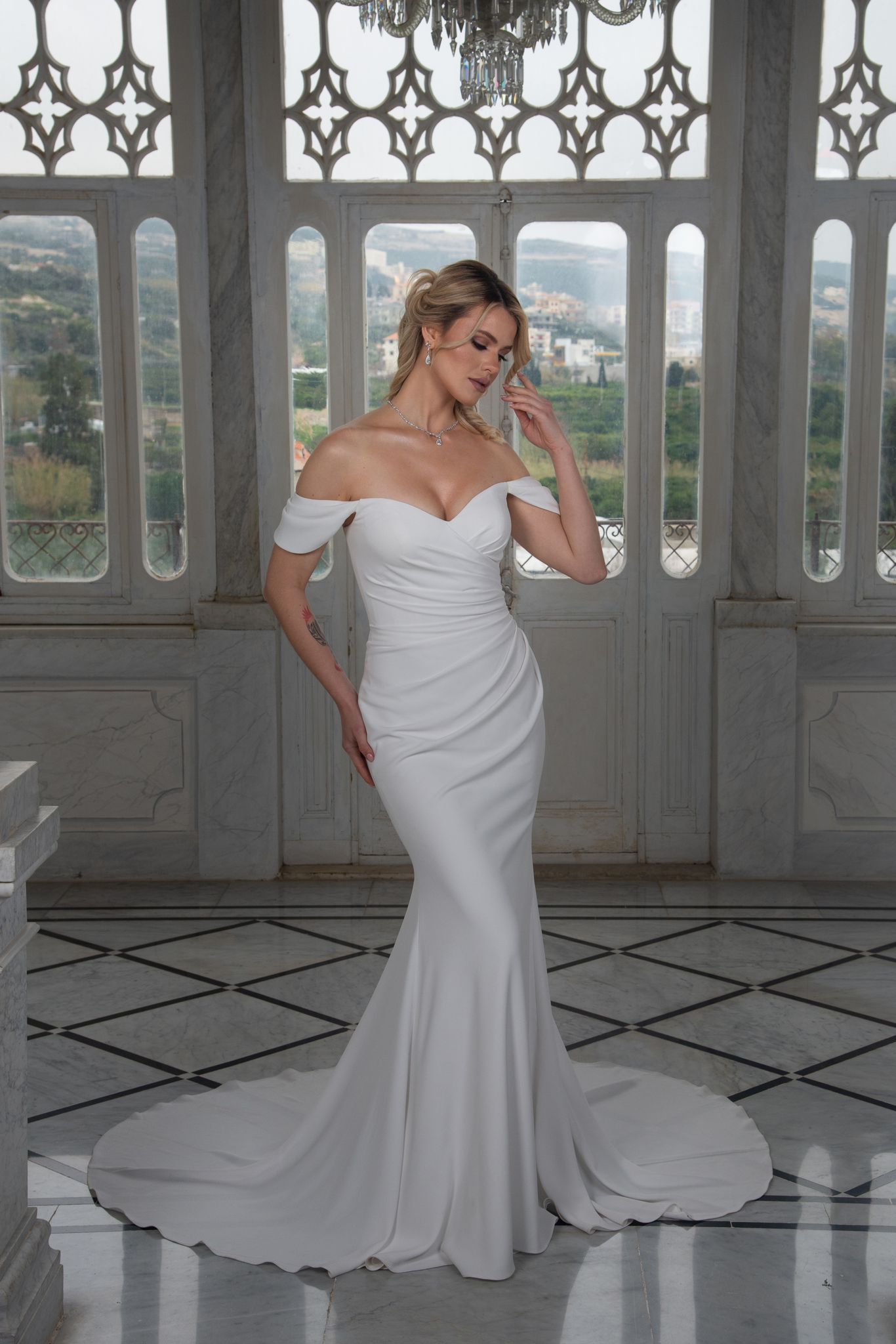 simple minimalistic wedding dress with ruching and off the shoulder straps.